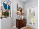 Entryway with wooden chest, lamp, and artwork at 156 Crevalle Rd, Rotonda West, FL 33947