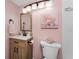 Bathroom with wood vanity and pink walls at 1591 Beach Rd # 402, Englewood, FL 34223