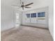 Bedroom with water views, ceiling fan and carpet flooring at 2424 Placida Rd # C202, Englewood, FL 34224