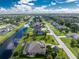 Aerial view of canal front home with pool and large backyard at 230 Long Meadow Ln, Rotonda West, FL 33947