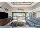 Relaxing living area with a view of the pool and patio through sliding glass doors at 230 Long Meadow Ln, Rotonda West, FL 33947