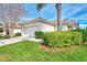 Single-story home with attached garage and lush landscaping at 3390 Osprey Ln, Port Charlotte, FL 33953