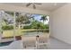 Relaxing screened porch with table and chairs, overlooking the backyard at 3390 Osprey Ln, Port Charlotte, FL 33953