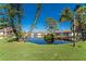 Picturesque pond with a wooden dock and lush greenery at 404 Pine Hollow Cir # 404, Englewood, FL 34223
