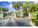 Gated entrance to Pine Hollow community with landscaping and signage at 404 Pine Hollow Cir # 404, Englewood, FL 34223