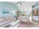 Open living area with white sofas and a view into the dining area and kitchen at 404 Pine Hollow Cir # 404, Englewood, FL 34223