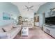 Open living area with white sofas and a view into the dining area and kitchen at 404 Pine Hollow Cir # 404, Englewood, FL 34223