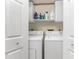 Bright laundry room with washer, dryer, and storage cabinets at 404 Pine Hollow Cir # 404, Englewood, FL 34223