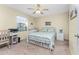Cozy bedroom with a metal bed frame, dresser, and workspace at 404 Pine Hollow Cir # 404, Englewood, FL 34223