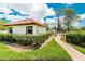 Community pool area with surrounding landscaping and walkway at 404 Pine Hollow Cir # 404, Englewood, FL 34223