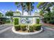Gated entrance to Pine Hollow community with landscaping and signage at 404 Pine Hollow Cir # 404, Englewood, FL 34223