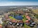 Aerial view highlighting a condo unit near a lake and the surrounding community at 404 Pine Hollow Cir # 404, Englewood, FL 34223