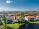 Aerial view of condo buildings near a lake and surrounding landscape at 404 Pine Hollow Cir # 404, Englewood, FL 34223
