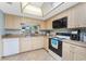 Spacious kitchen with light wood cabinets and modern appliances at 404 Pine Hollow Cir # 404, Englewood, FL 34223