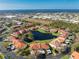 Aerial view showcasing a condo unit near a lake and surrounding community at 404 Pine Hollow Cir # 404, Englewood, FL 34223