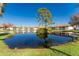 Community features a lake with a wooden dock and lush landscaping at 404 Pine Hollow Cir # 404, Englewood, FL 34223
