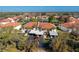 Aerial view of condo community, showing buildings, parking, and a lake at 404 Pine Hollow Cir # 404, Englewood, FL 34223