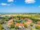Aerial view of waterfront community with lush landscaping and a pond at 404 Pine Hollow Cir # 404, Englewood, FL 34223