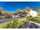 Building exterior with covered parking and lush landscaping at 404 Pine Hollow Cir # 404, Englewood, FL 34223