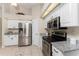 Modern kitchen with stainless steel appliances and white cabinets at 110 Abercrombie Ave, Englewood, FL 34223