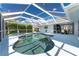 Relaxing kidney-shaped pool with a spa and screened-in patio at 110 Abercrombie Ave, Englewood, FL 34223