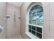 Walk-in shower with large window at 110 Abercrombie Ave, Englewood, FL 34223