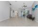 Spacious living room with tiled floors and access to the pool area at 110 Abercrombie Ave, Englewood, FL 34223