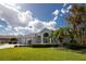 Spacious home exterior with lush landscaping and a two-car garage at 110 Abercrombie Ave, Englewood, FL 34223