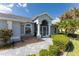 Well-maintained home exterior with attractive landscaping and walkway at 110 Abercrombie Ave, Englewood, FL 34223