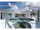 Large screened pool and spa with adjacent patio and kitchen views at 110 Abercrombie Ave, Englewood, FL 34223