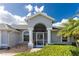 Charming home with a welcoming front porch and manicured landscaping at 110 Abercrombie Ave, Englewood, FL 34223