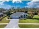 House exterior featuring a three-car garage and a nicely landscaped yard at 110 Abercrombie Ave, Englewood, FL 34223