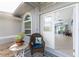 Inviting front porch with wicker chair and side view into the house at 110 Abercrombie Ave, Englewood, FL 34223