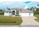 House with a three car garage and paver driveway at 12194 Everglades Ave, Port Charlotte, FL 33981