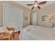 Bright bedroom with a comfortable bed, wicker chair, and ample closet space at 13025 Cedar Creek Dr, Port Charlotte, FL 33953