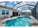 Enjoy this refreshing pool with a screened enclosure and patio seating at 13324 Golf Pointe Dr, Port Charlotte, FL 33953