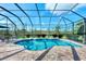 Inviting screened pool area with spacious patio and lush landscaping at 13324 Golf Pointe Dr, Port Charlotte, FL 33953