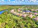 Aerial view of a luxury community with houses, lakes, and lush landscaping at 13324 Golf Pointe Dr, Port Charlotte, FL 33953