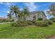 House exterior with lush landscaping and a green facade at 13783 Palmetto Point Ct, Port Charlotte, FL 33953