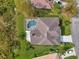 Bird's-eye view of house with pool and courtyard at 13783 Palmetto Point Ct, Port Charlotte, FL 33953