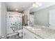 Bathroom with shower/tub combo, granite countertop, and decorative shower curtain at 152 Apollo Dr, Rotonda West, FL 33947