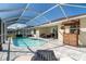 Large refreshing pool with screened enclosure and patio furniture at 152 Apollo Dr, Rotonda West, FL 33947