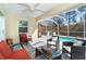 Enclosed pool and patio area with seating and a tiki bar at 152 Apollo Dr, Rotonda West, FL 33947