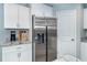 Kitchen boasts stainless steel refrigerator and white cabinetry at 152 Apollo Dr, Rotonda West, FL 33947