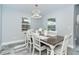 Charming dining room featuring a dark wood table and white chairs at 152 Apollo Dr, Rotonda West, FL 33947
