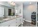 Double vanity bathroom with granite countertops and large mirror at 152 Apollo Dr, Rotonda West, FL 33947