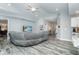 Open and bright living room with a large sectional sofa and view of the kitchen at 152 Apollo Dr, Rotonda West, FL 33947
