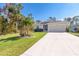 Single-story home with a two-car garage and well-manicured lawn at 152 Apollo Dr, Rotonda West, FL 33947