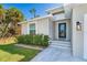 Inviting front entrance with a modern door and landscaping at 152 Apollo Dr, Rotonda West, FL 33947