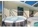 Enjoy this hot tub with views of the pool and patio at 152 Apollo Dr, Rotonda West, FL 33947